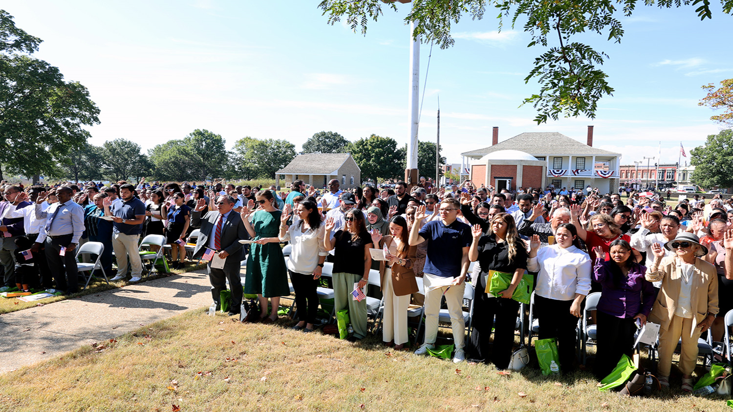 199 new us citizens taking their oath on the fort's parade ground.