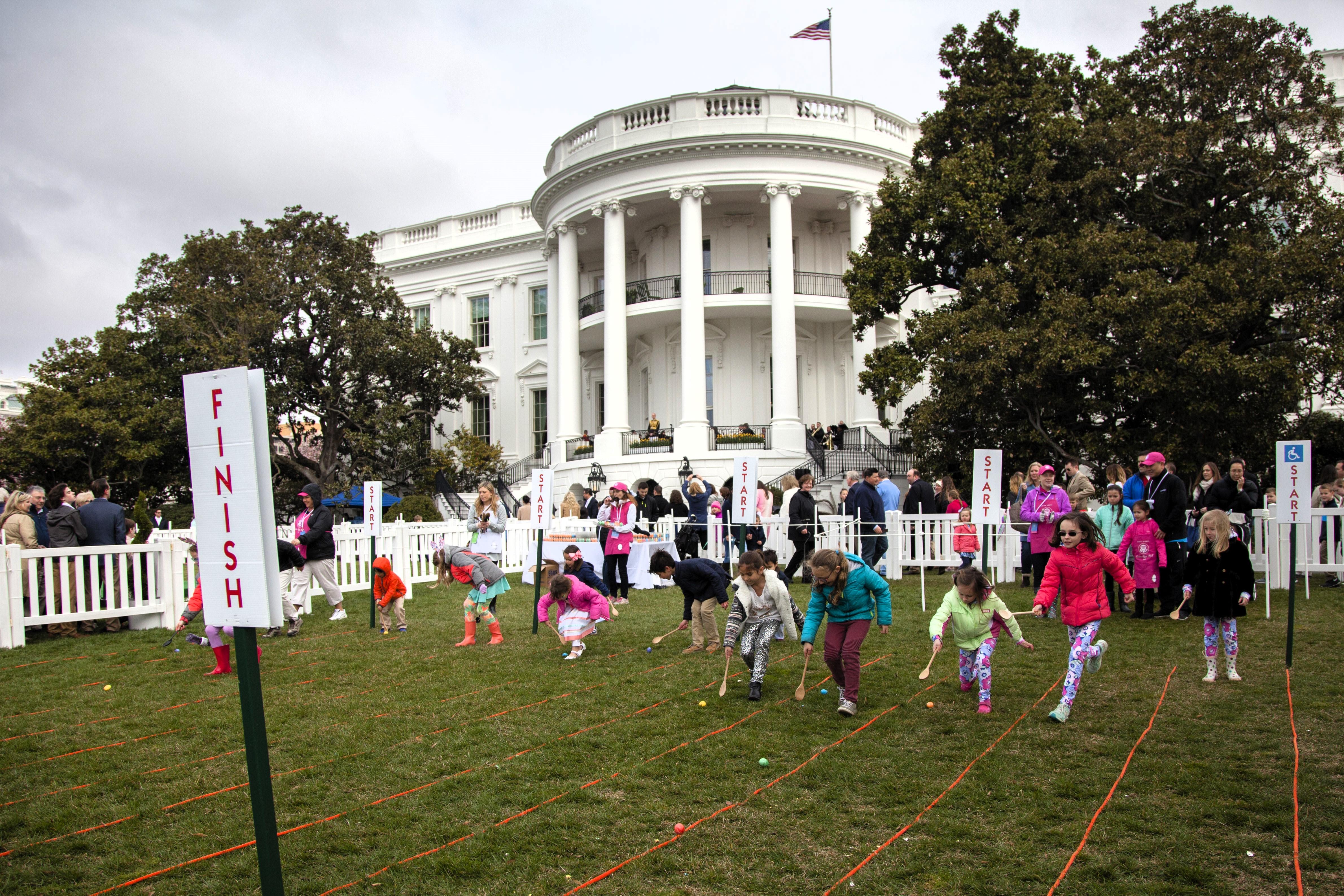 Children roll Easter eggs on the South Lawn