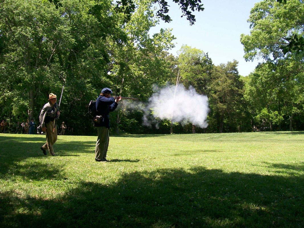 Living historian in Union uniform fires a musket