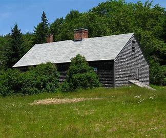 old building with gray shingle siding.