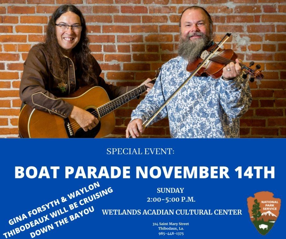 A guitar player and a fiddle play stand in front of a brick wall. NPS arrowhead logo with event text
