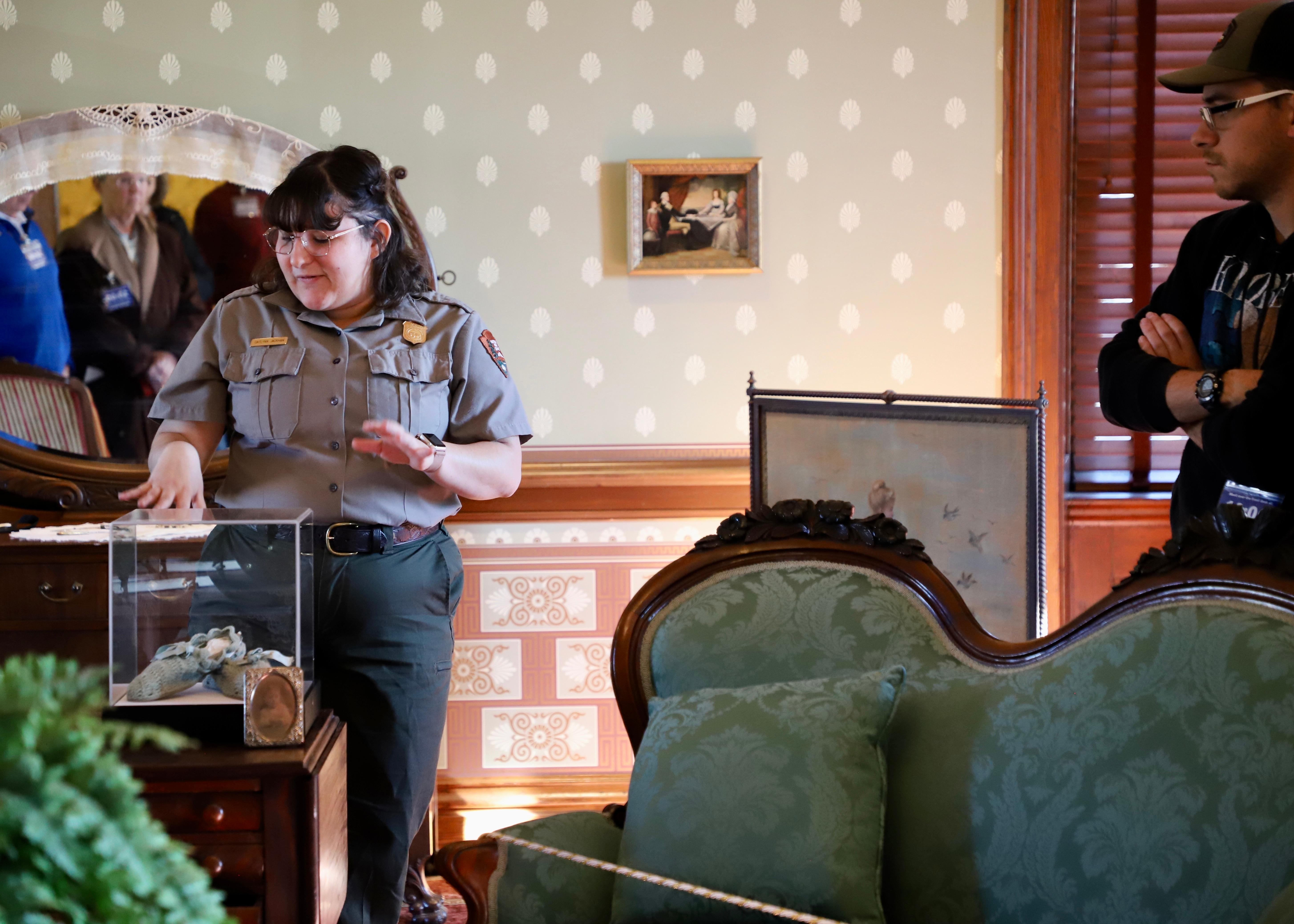park ranger points to a pair of crochet slippers
