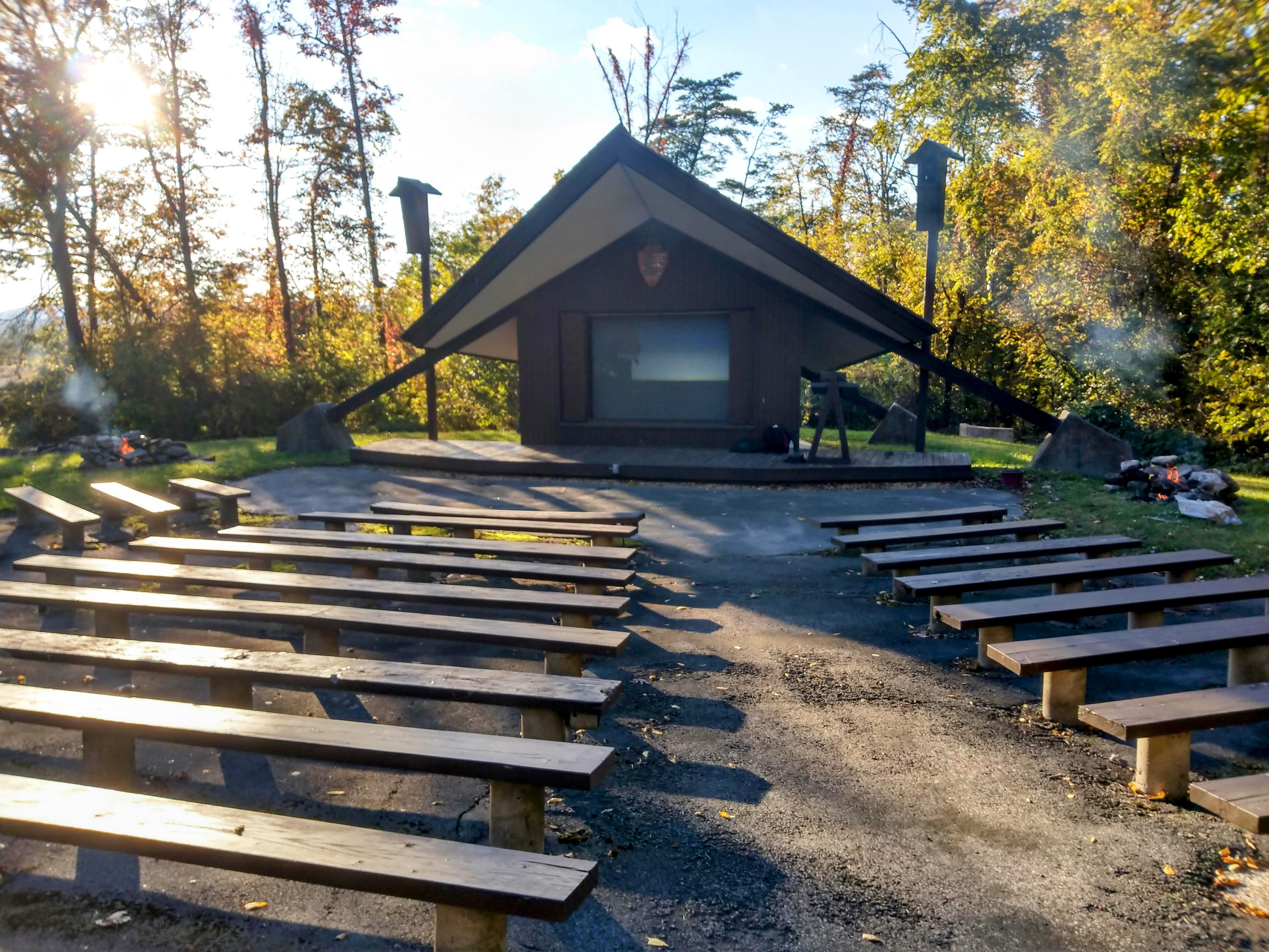 Amphitheater with wooden benches and two fires