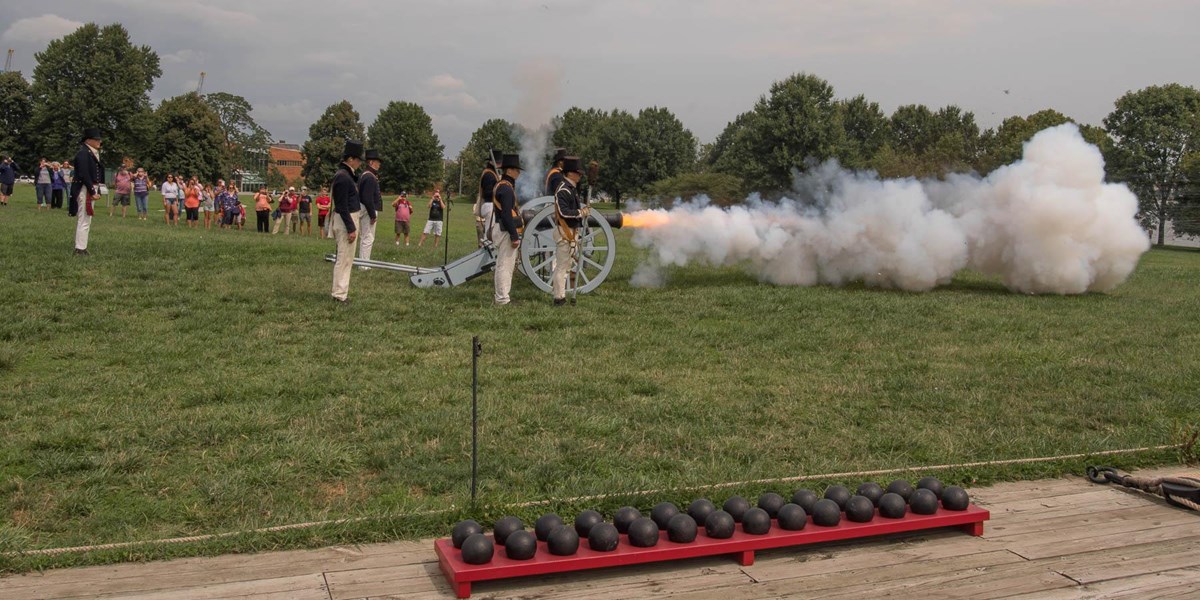 Living history staff fire a cannon on the park grounds.