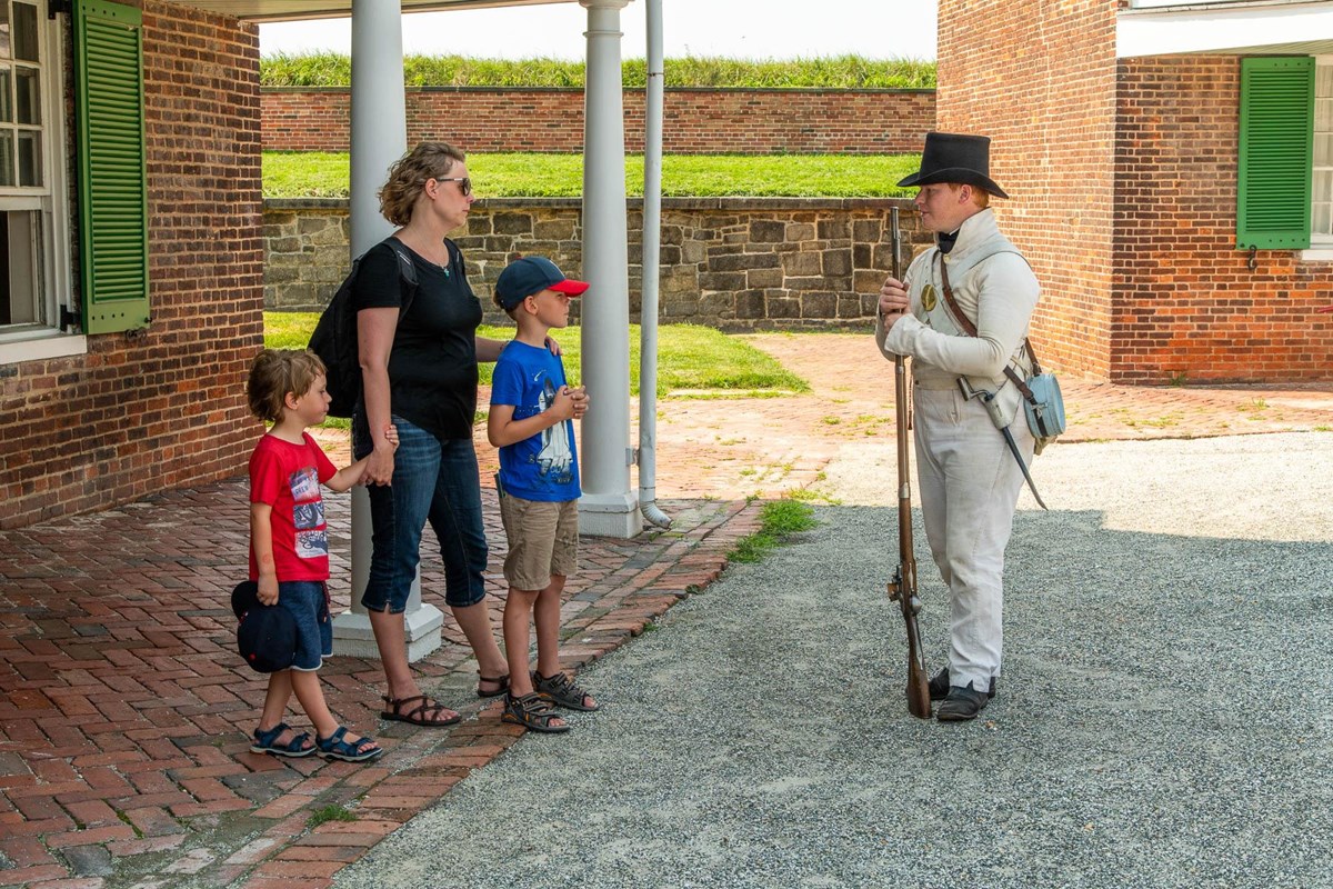 Living History staff talking with visitors inside the Star Fort.