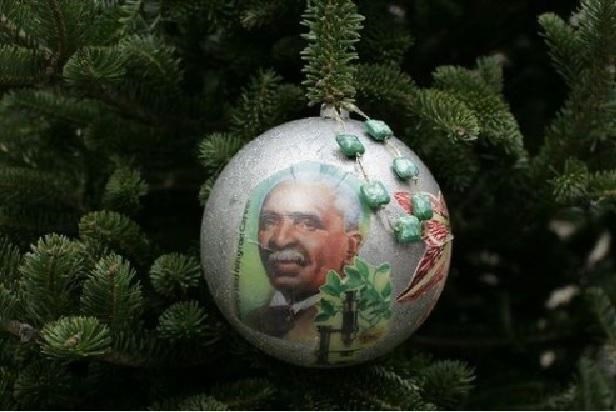 Hand-painted holiday ornament with George Washington Carver's face.