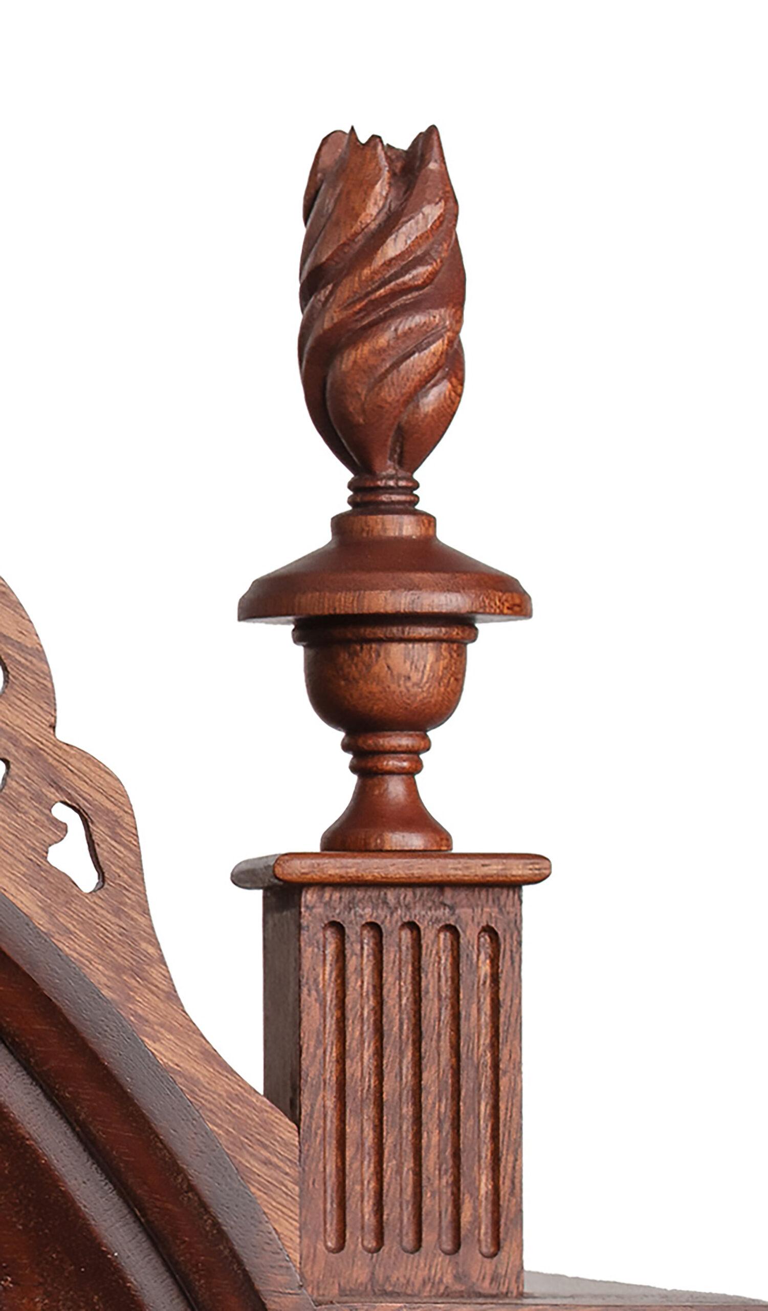 A close-up of a wooden element on a 19th century lady's work table