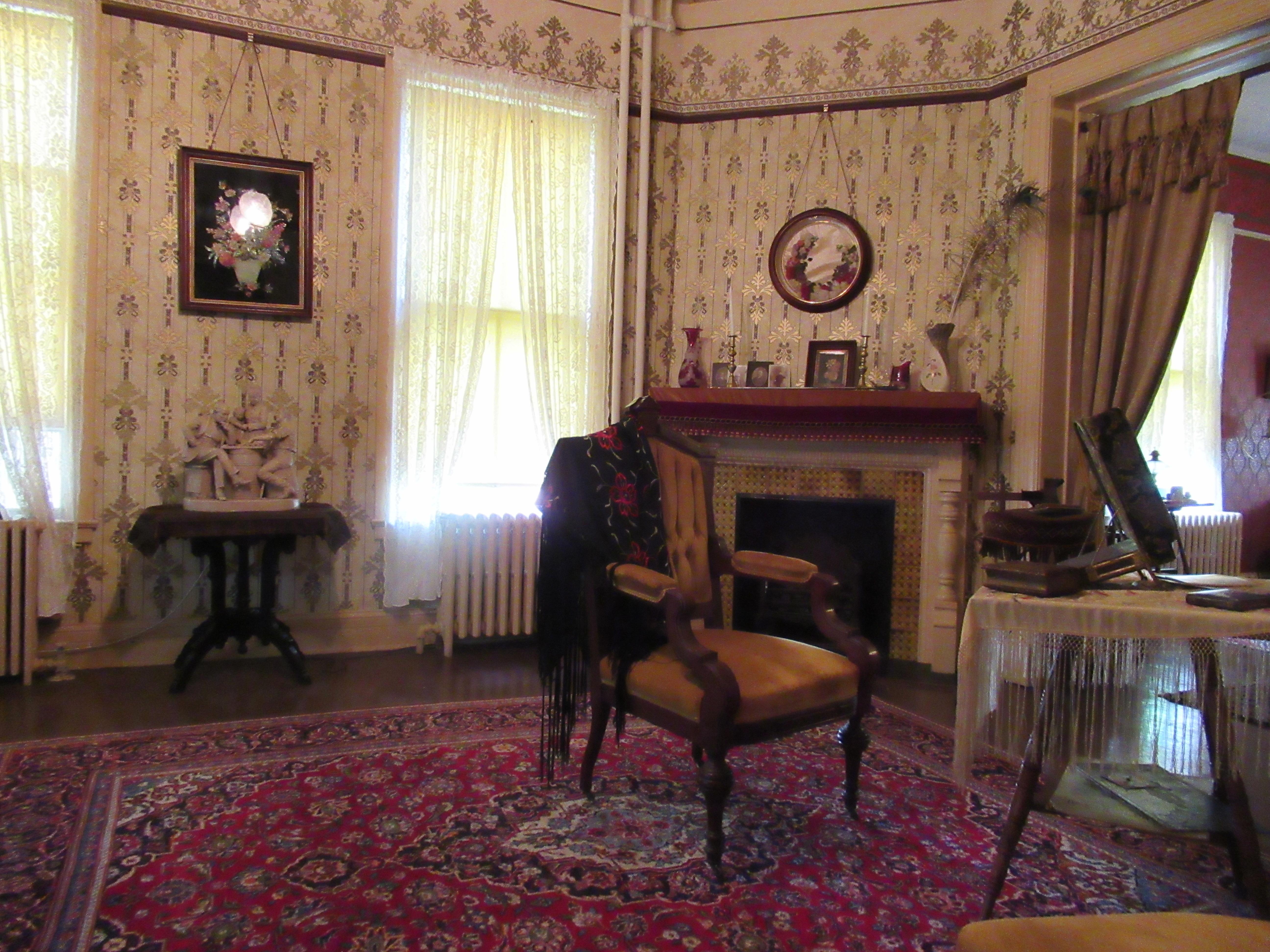 Sitting room with furniture, wall paper, and piano