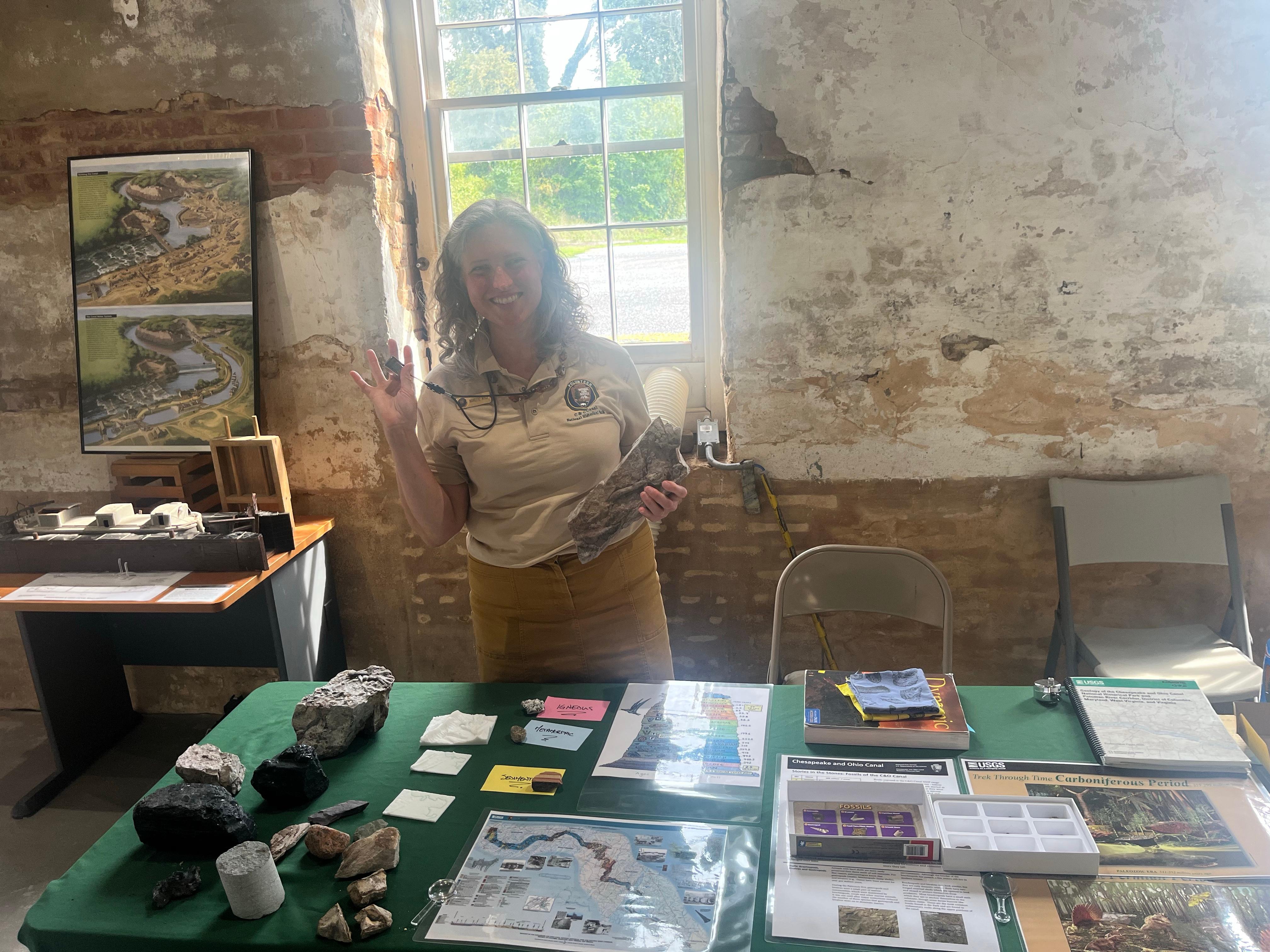 Volunteer stands with various geology information