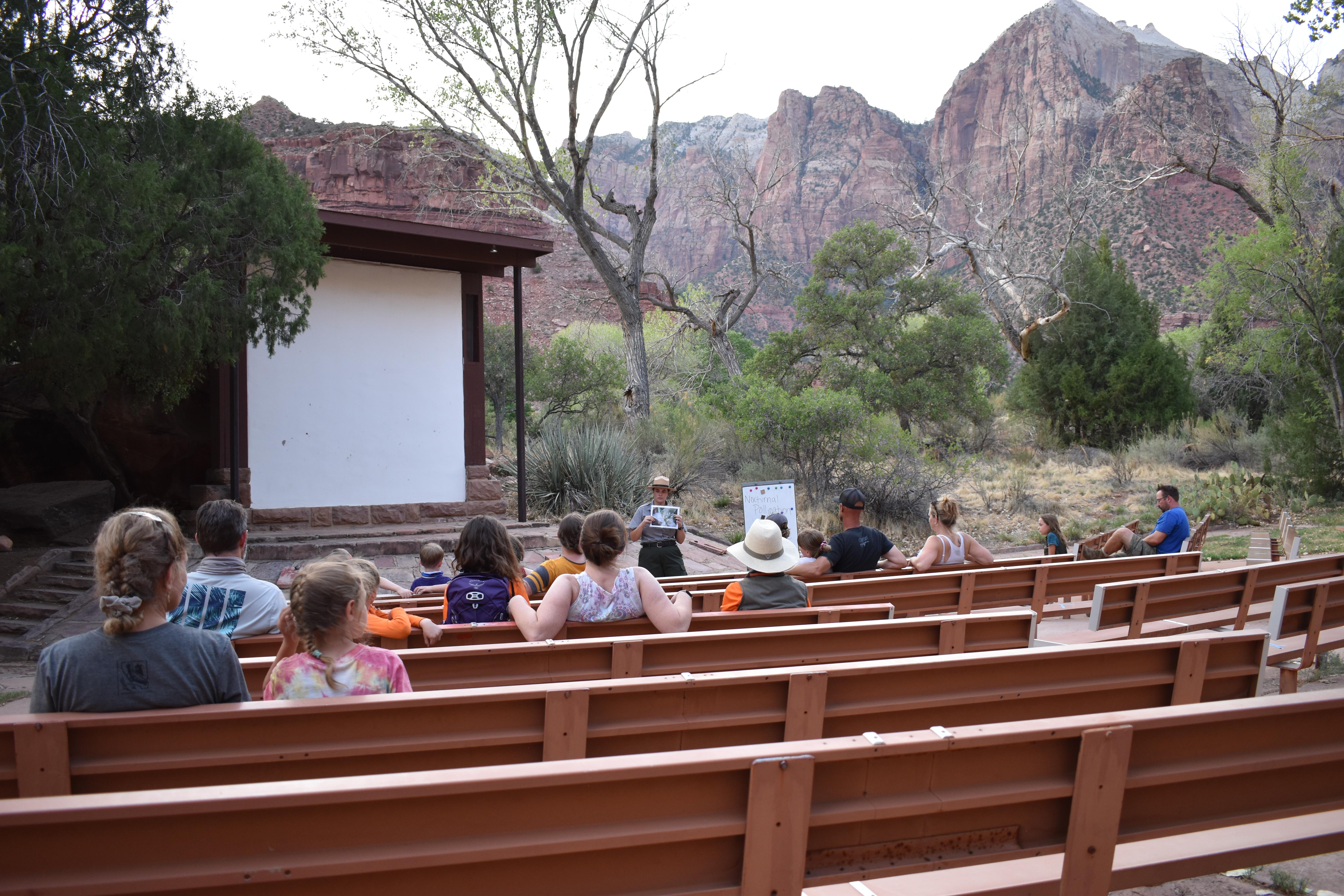 Ranger speaking in front of people sitting on benches