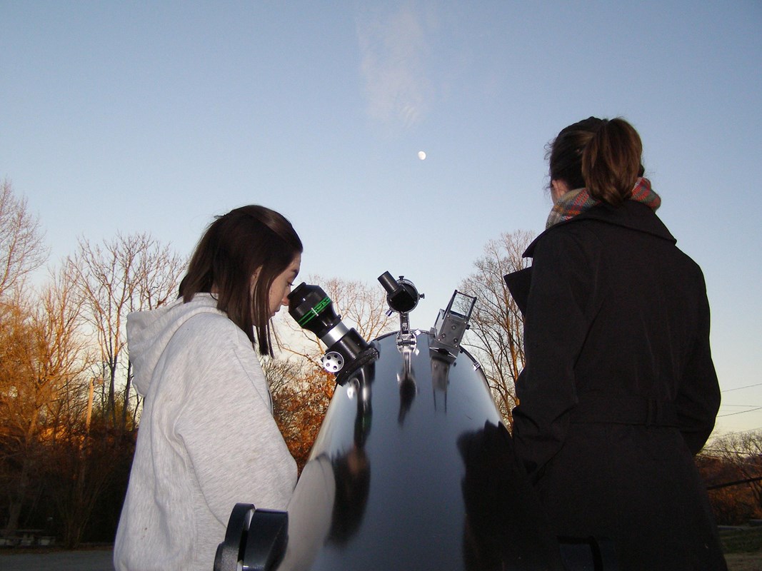 Visitors viewing stars through a telescope