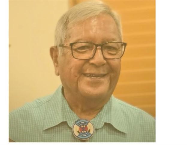 A man with glasses smiles at us