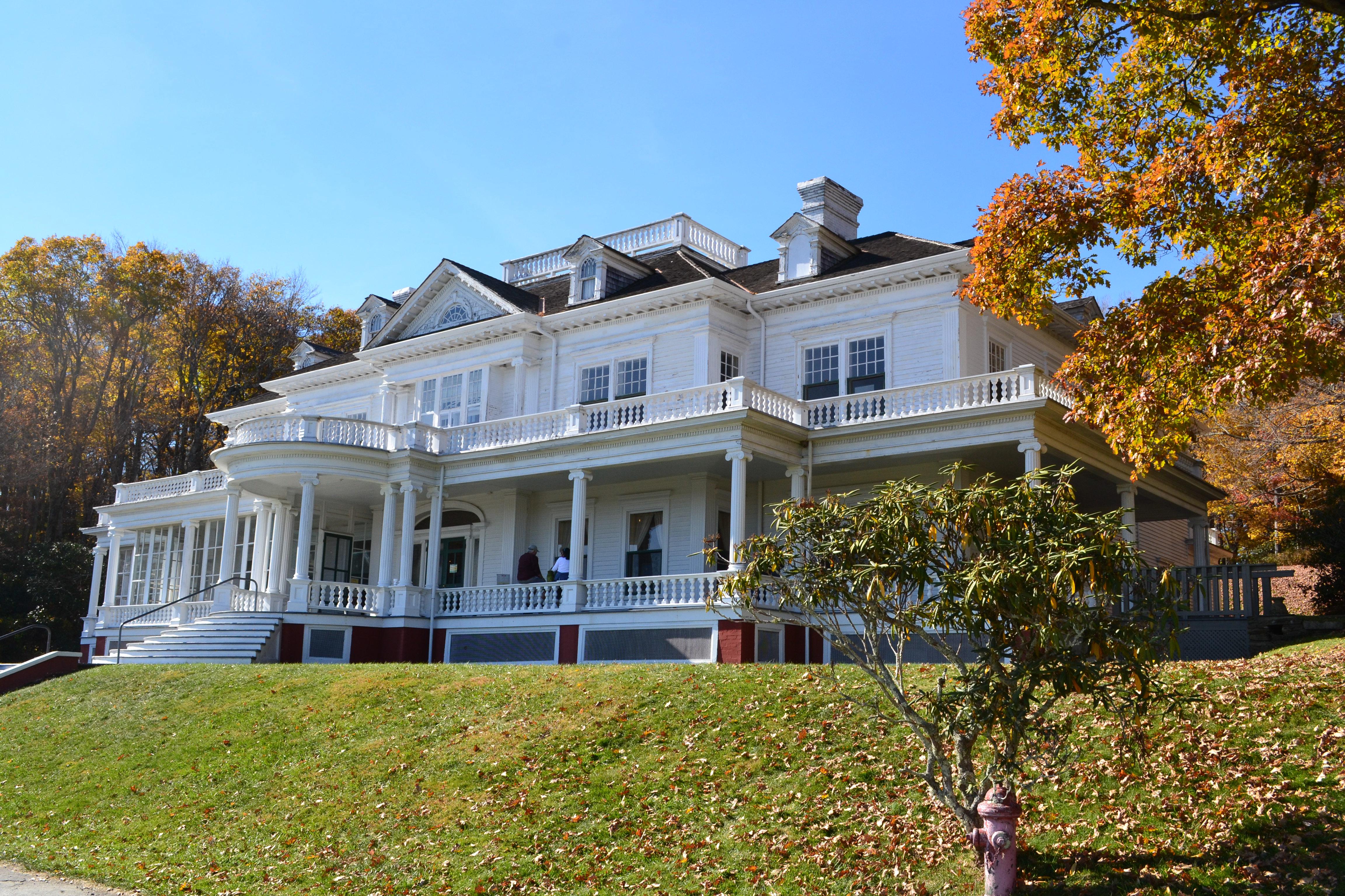 Exterior of Flat Top Manor on the Moses Cone Estate. A 3 story white mansion with wrap around porch.