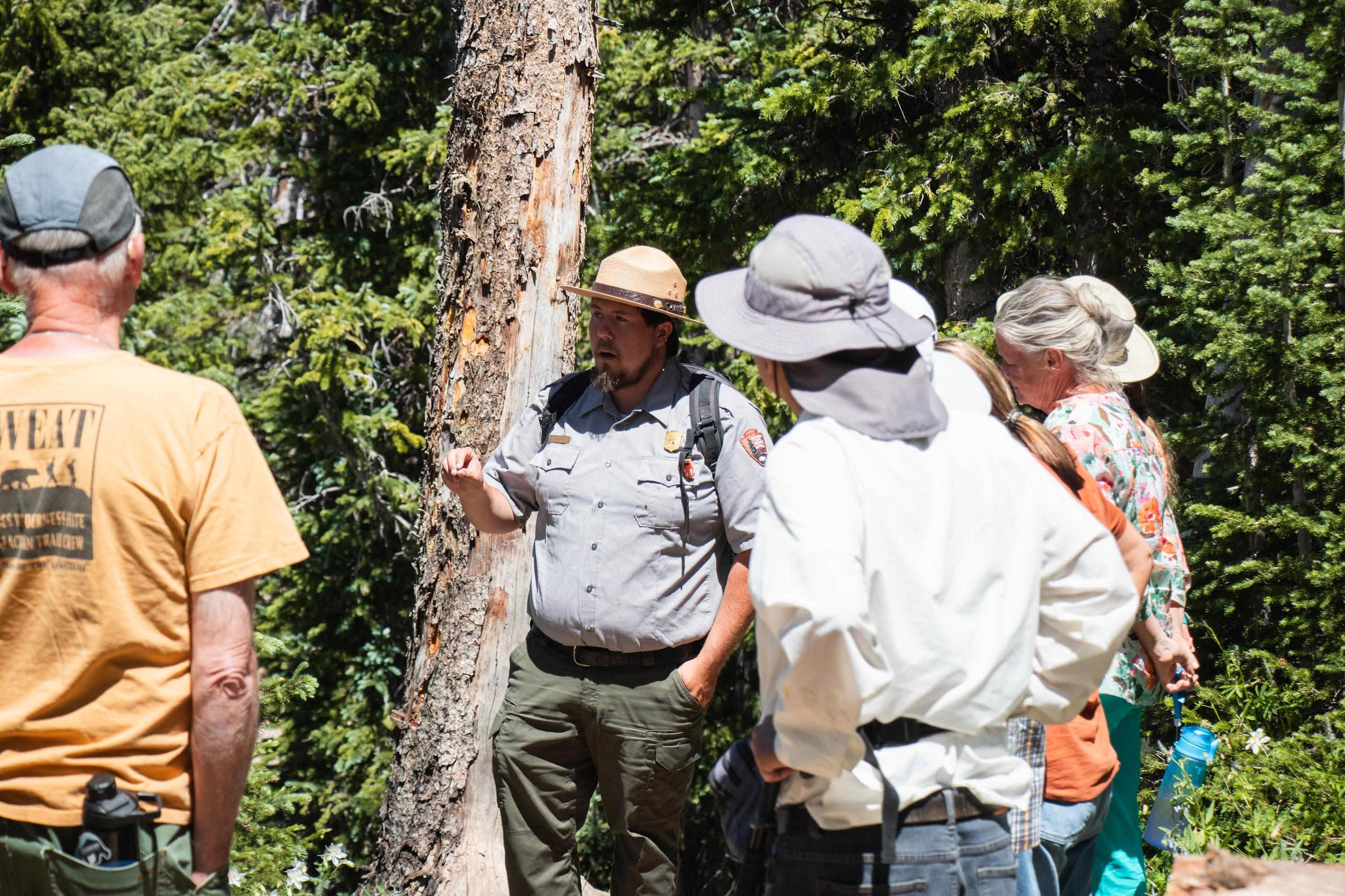 A ranger talks to a group of visitors.
