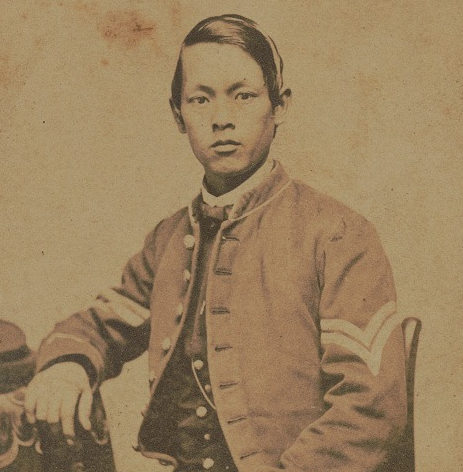 Asian man in civil war uniform posing for a photograph