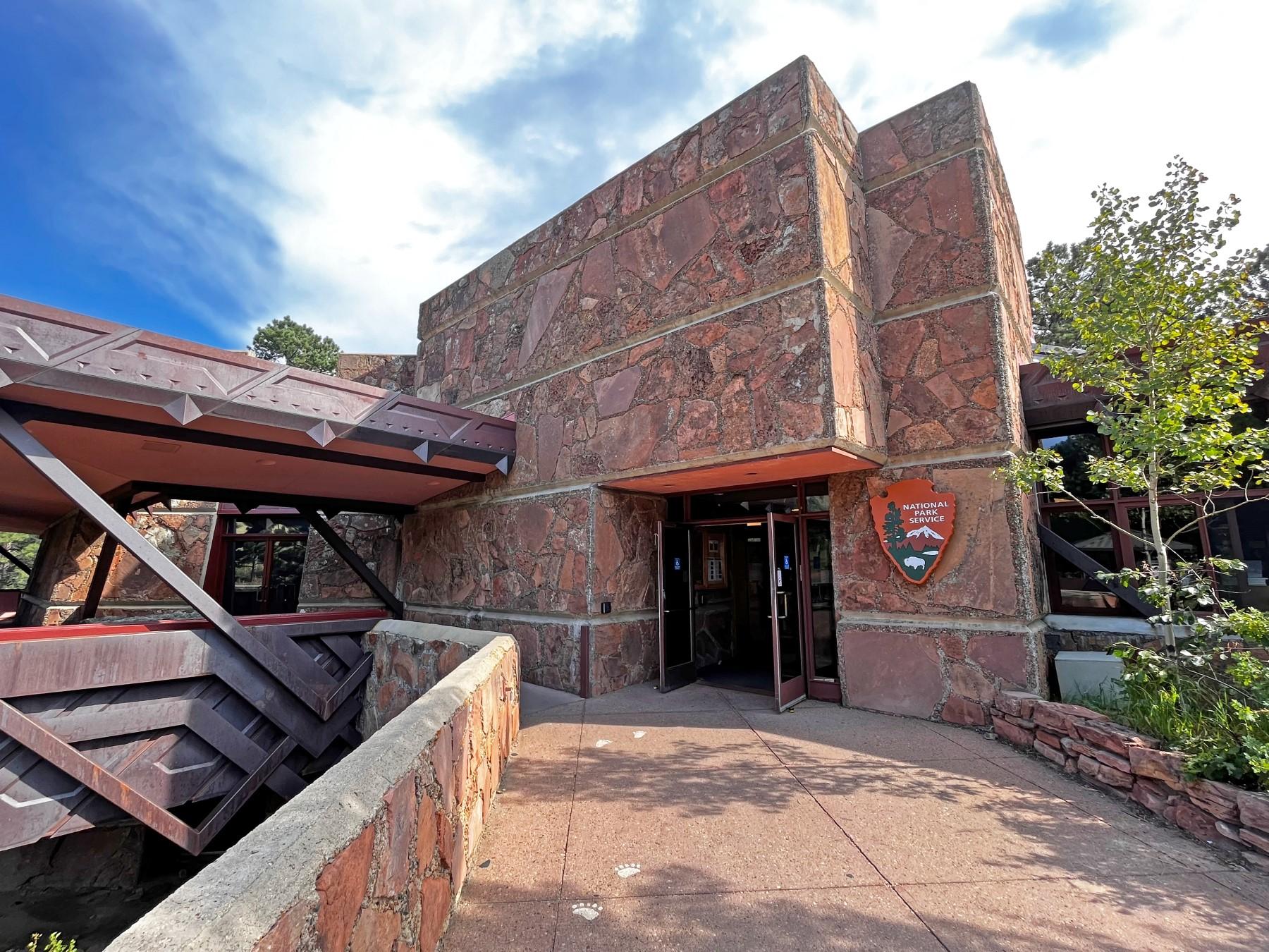 Front entrance to Beaver Meadows Visitor Center on a sunny day