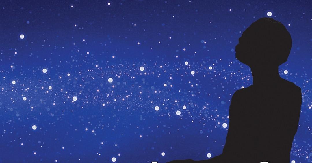 Silhouette of the young Carver statue with blue sky and white stars.