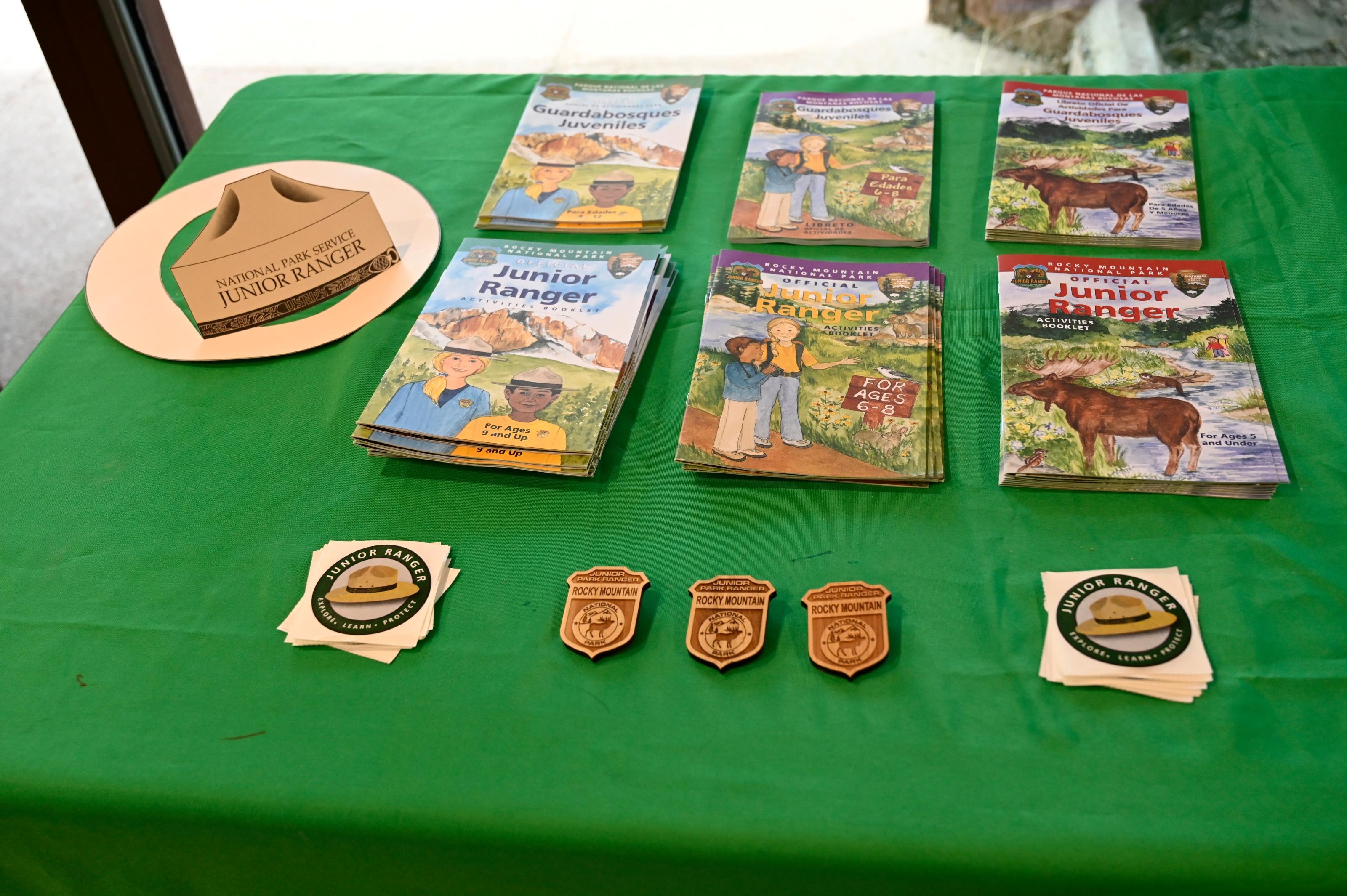 Junior Ranger books and badges are on display on top of a table