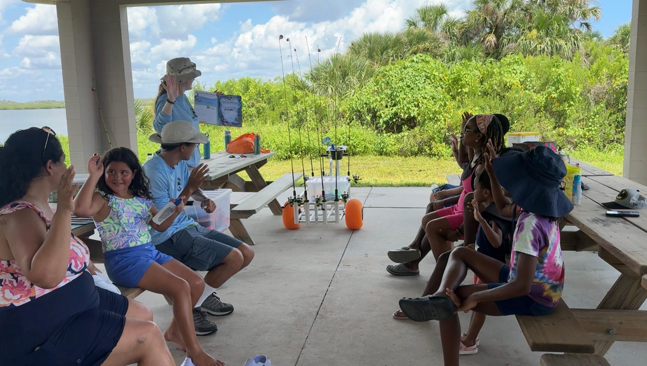 Jr Anglers learn about fishing under the pavilion.