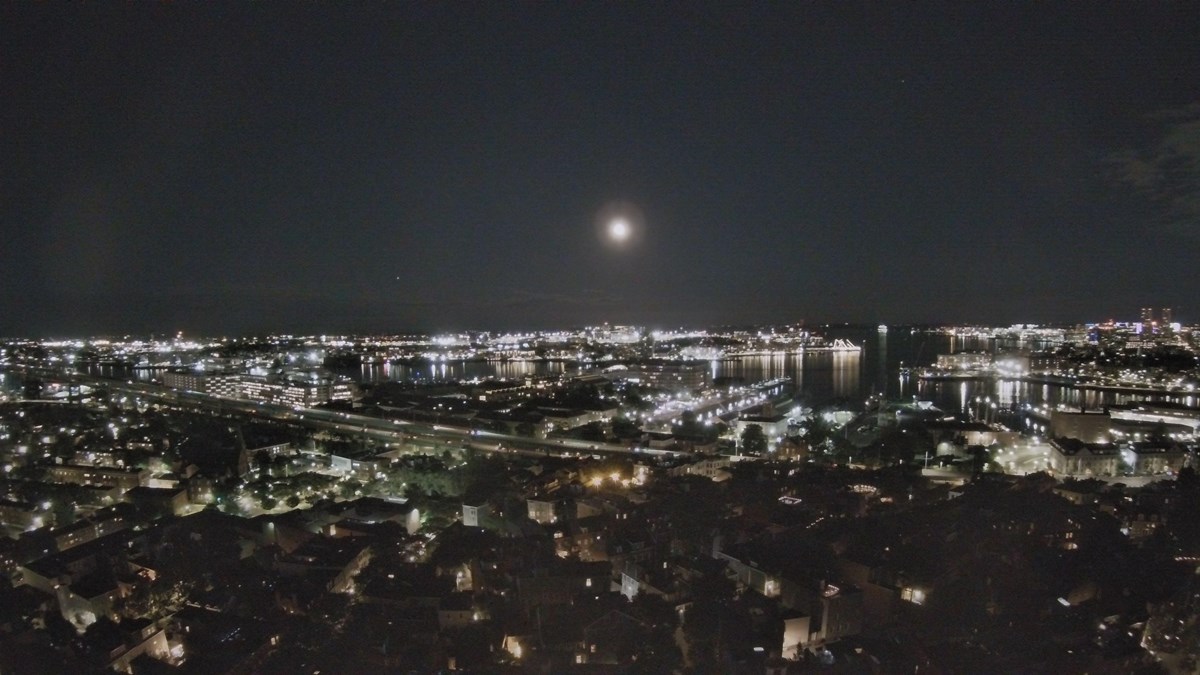 night view of the Charlestown Navy Yard from the top of the Bunker Hill Monument, with a full moon.