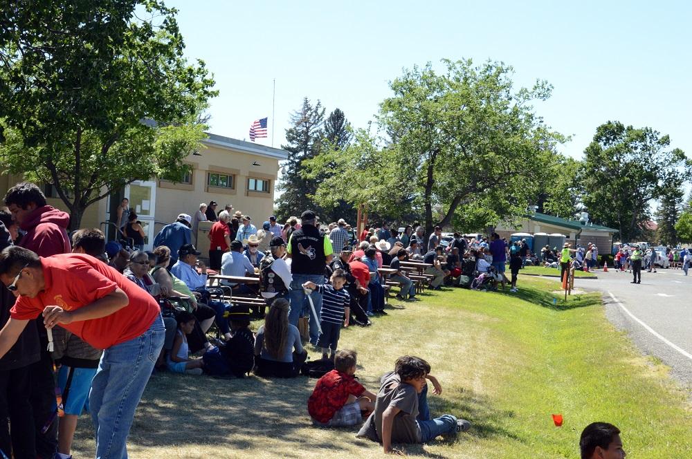 Many people standing in front of building facing road