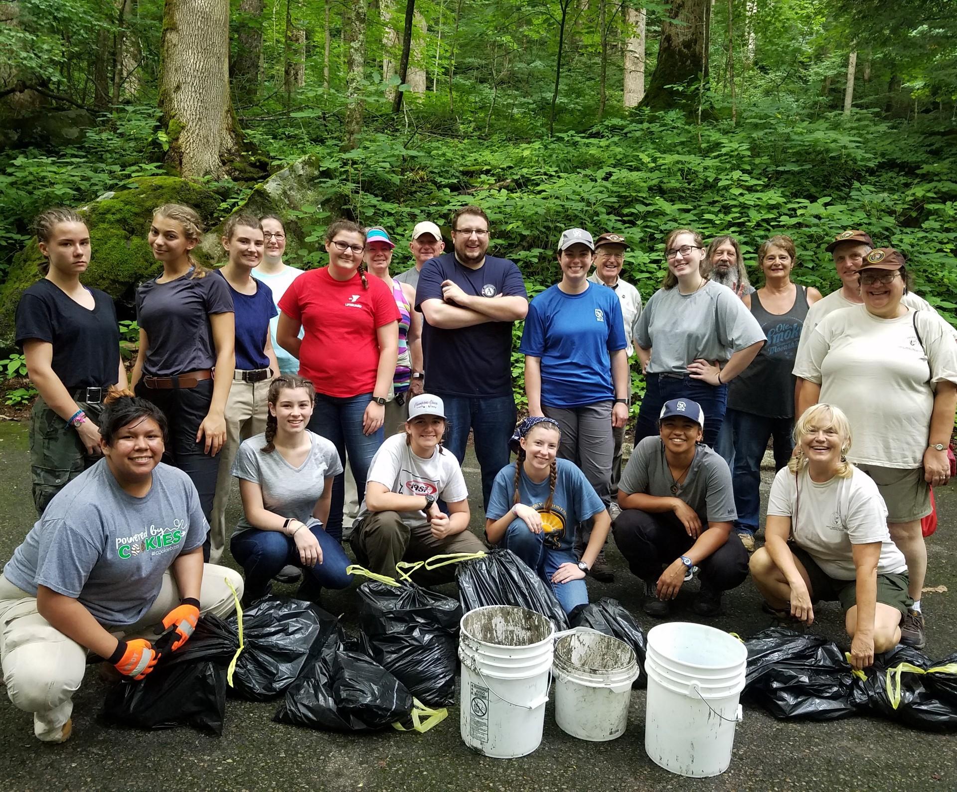A large group of volunteers at a clean-up posing for a group picture.