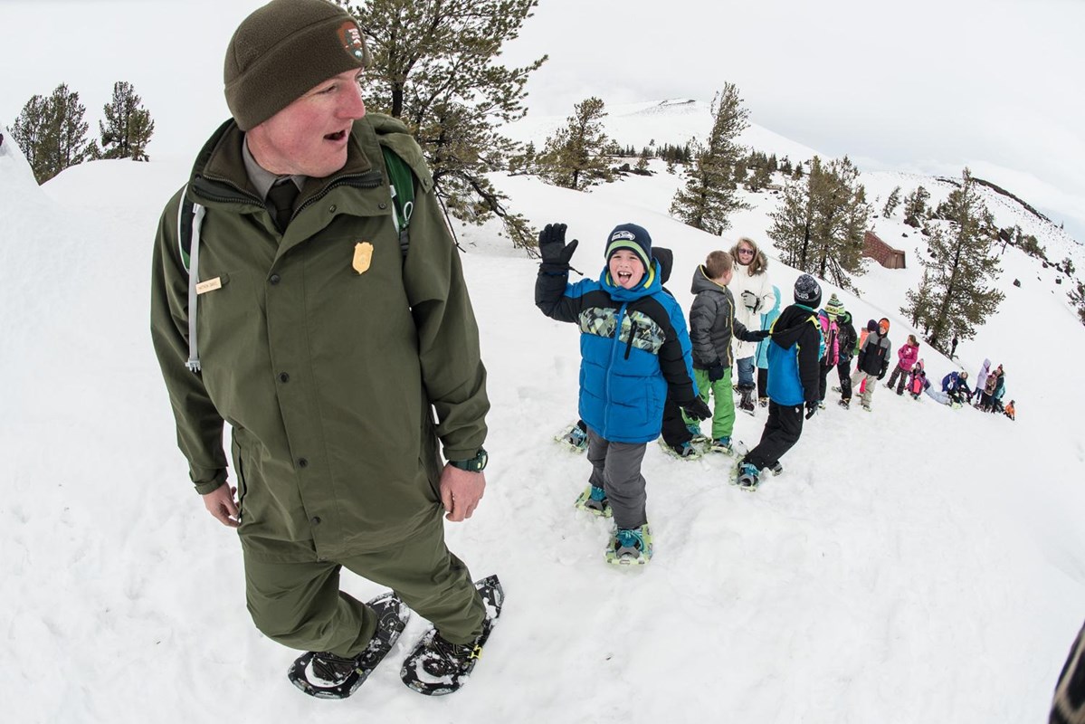Ranger leading children through snow