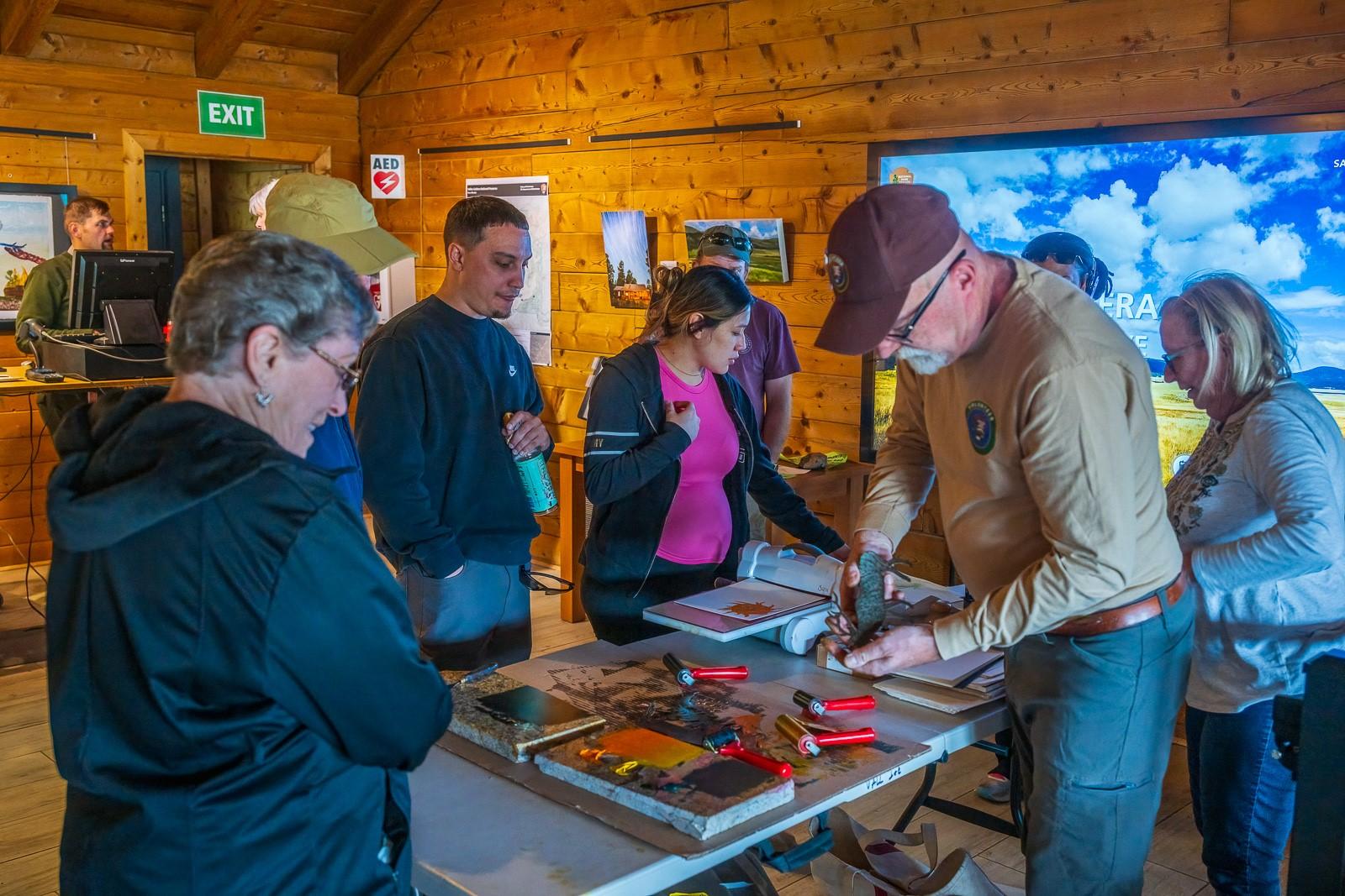 A park volunteer demonstrates the art of printmaking.