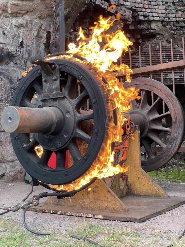 Mounted train wheels consumed by a ring of fire