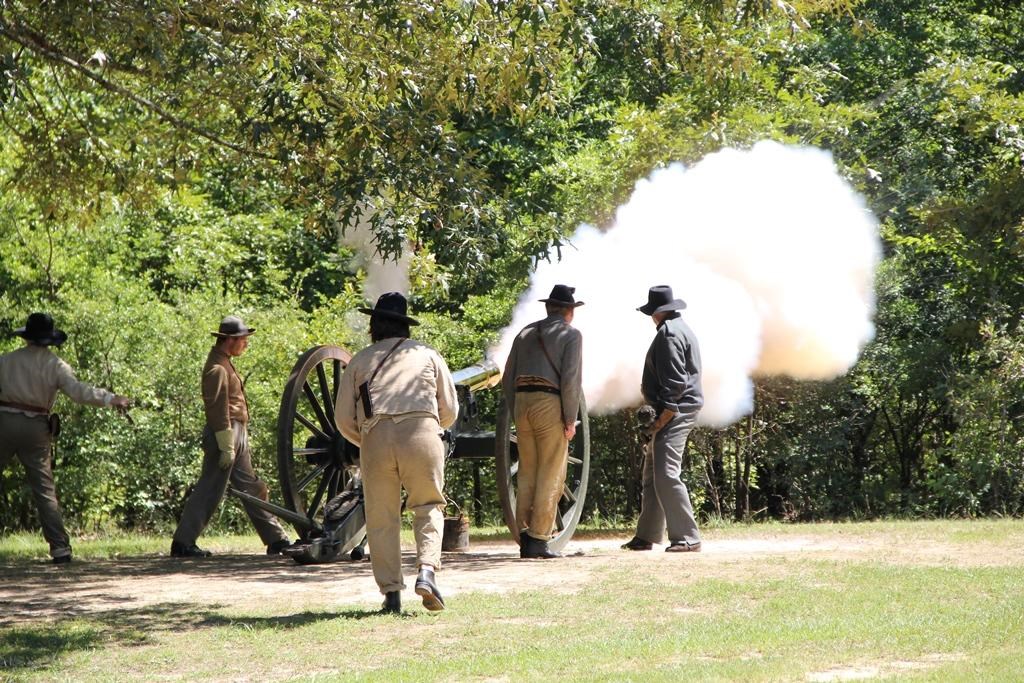 Living historians firing a cannon