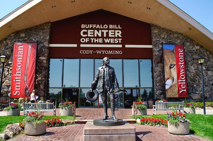 the front of a building with a statue