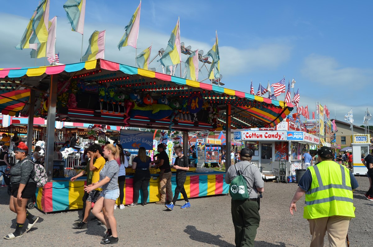 A ranger and volunteer blend in to a crowd at a family-friendly festival