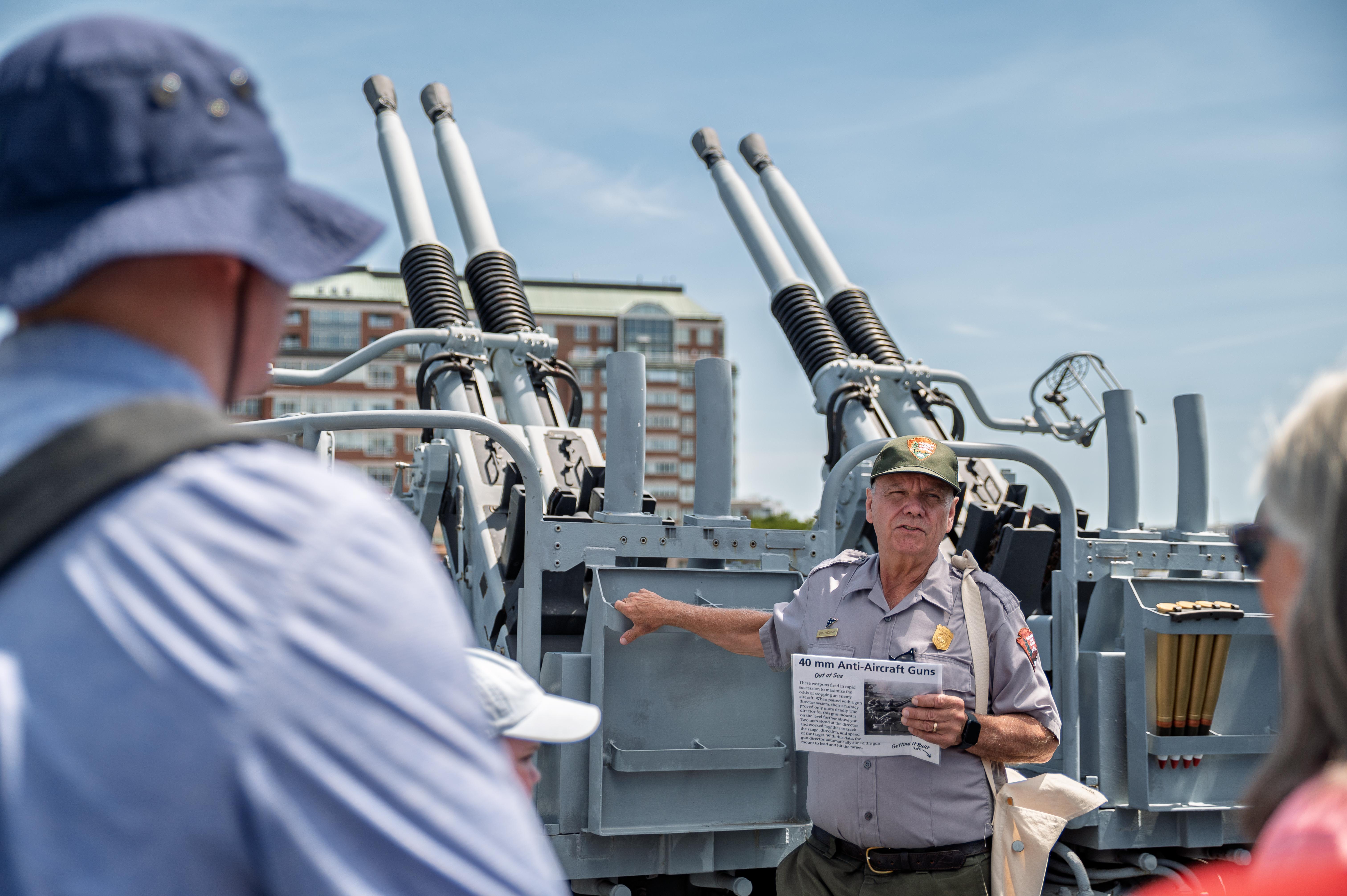 A ranger gives a tour on USS Cassin Young to visitors.