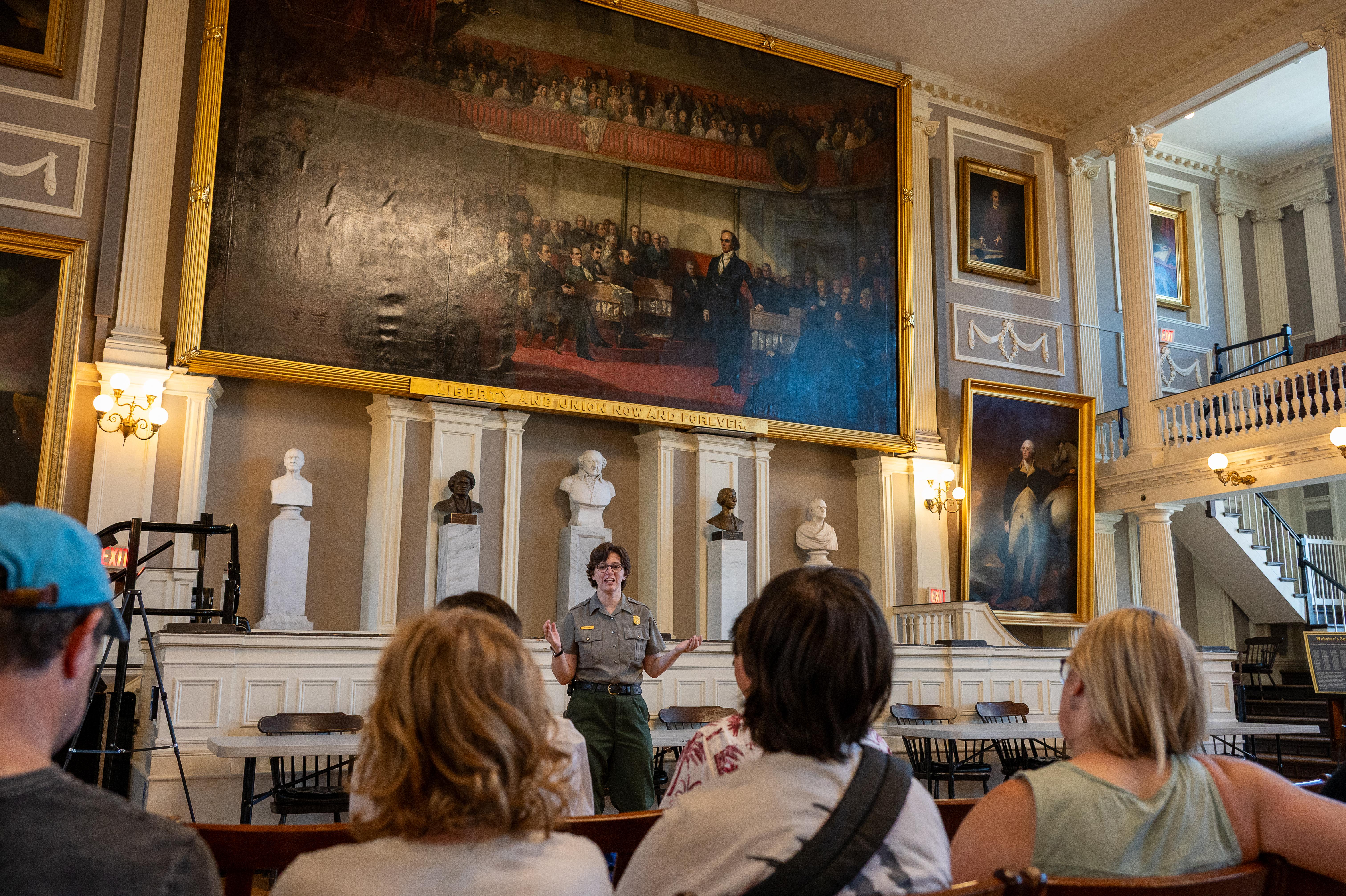 Ranger talking to a group of people in the Great Hall of Faneuil Hall