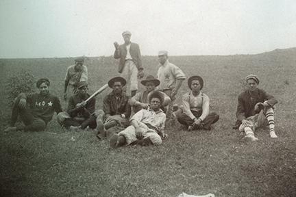 historic baseball team sitting on a hill
