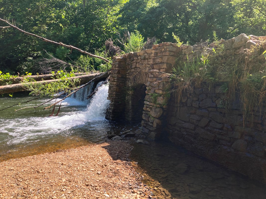 Water flowing over a stone dam