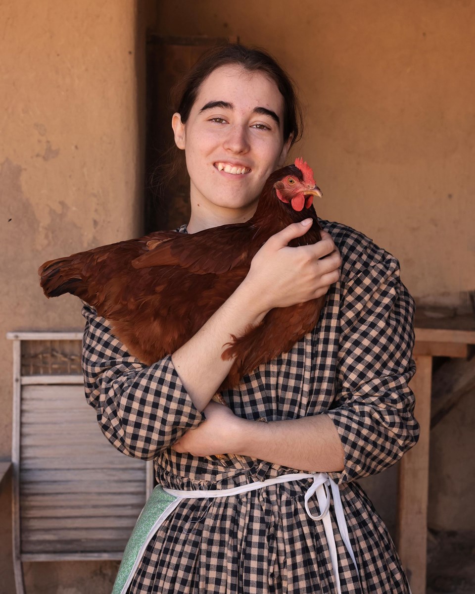 Living Historian (domestic) holding a hen