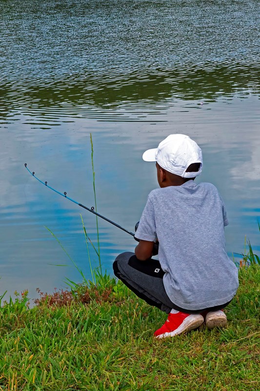 A young boy fishing.