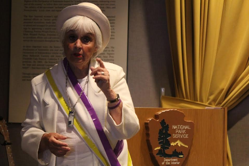Photo of Dr. Shaw wearing suffragette colors