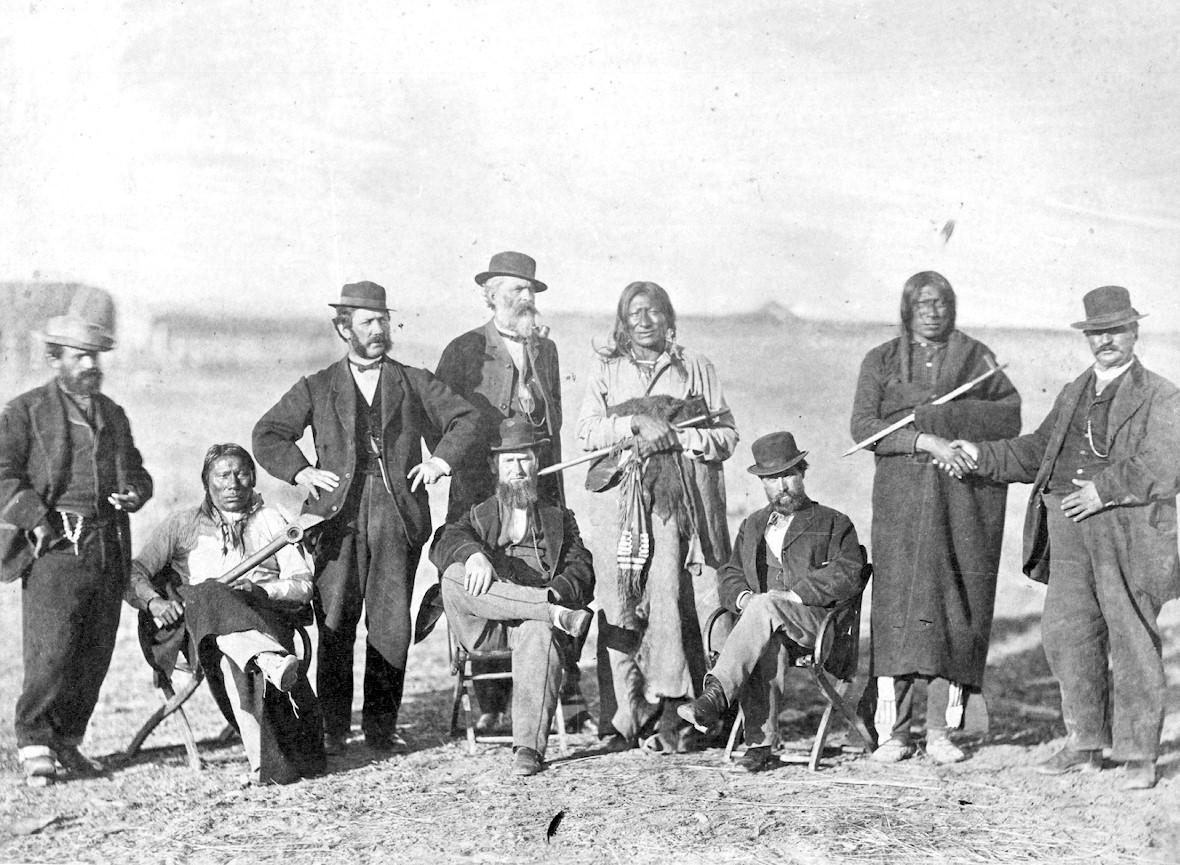 A group of Native American, white, and mixed heritage people posing for a photograph in the 1860s.