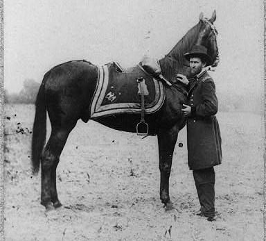 Grant in military uniform standing next to his horse Cincinnati