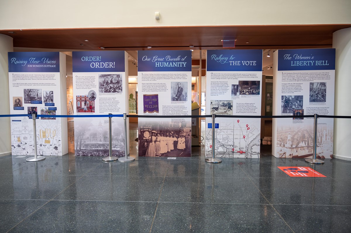 Photo of five freestanding exhibit panels in a row, each with colorful images and accompanying text.
