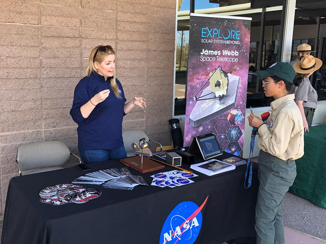 people stand around a table labeled NASA