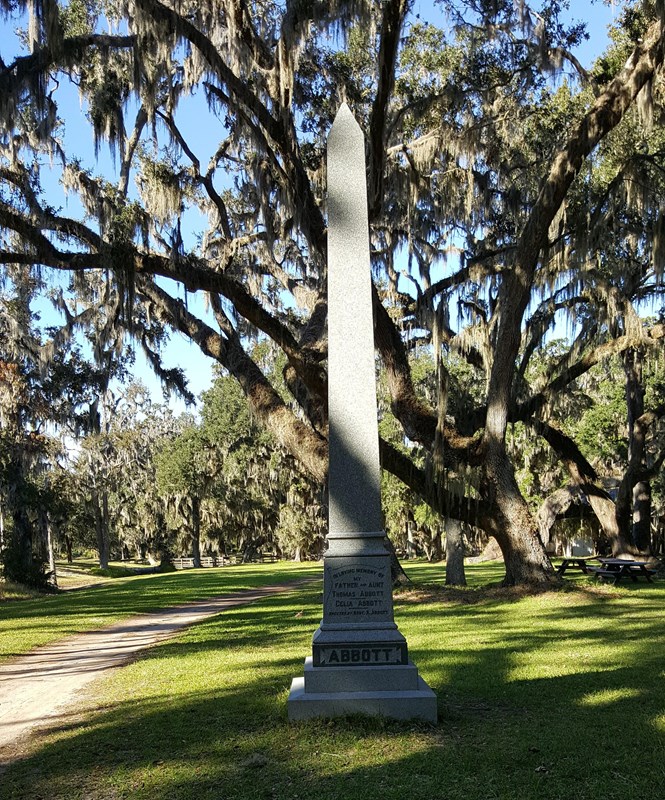 marble obelisk and live oak trees