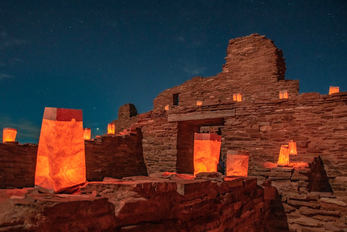 Luminarias sitting on top of red sandstone remnants.