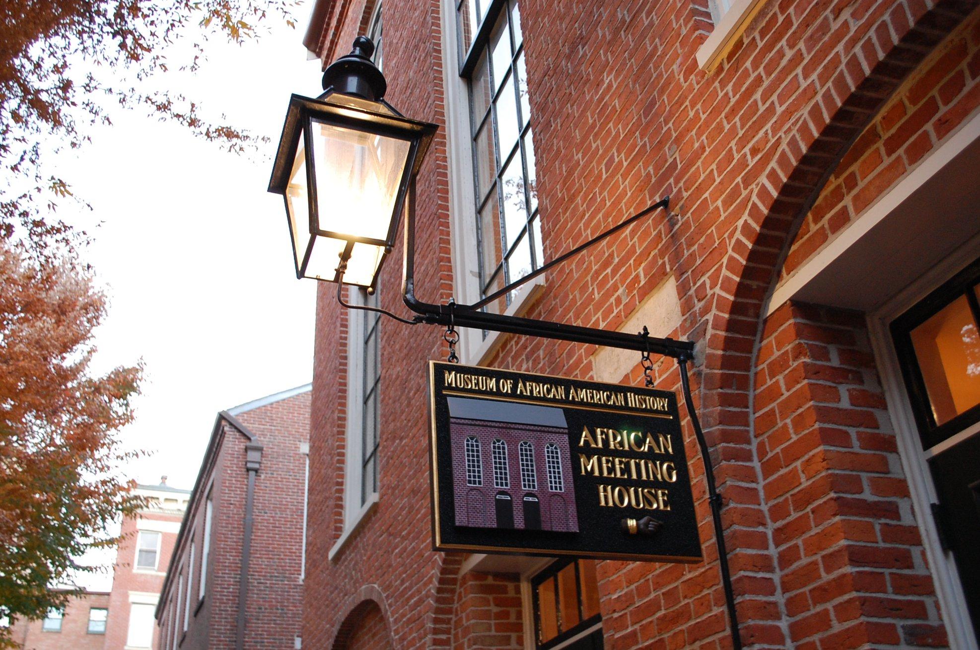 A sign at the entrance to the Museum of African American History is shown next to a lantern.