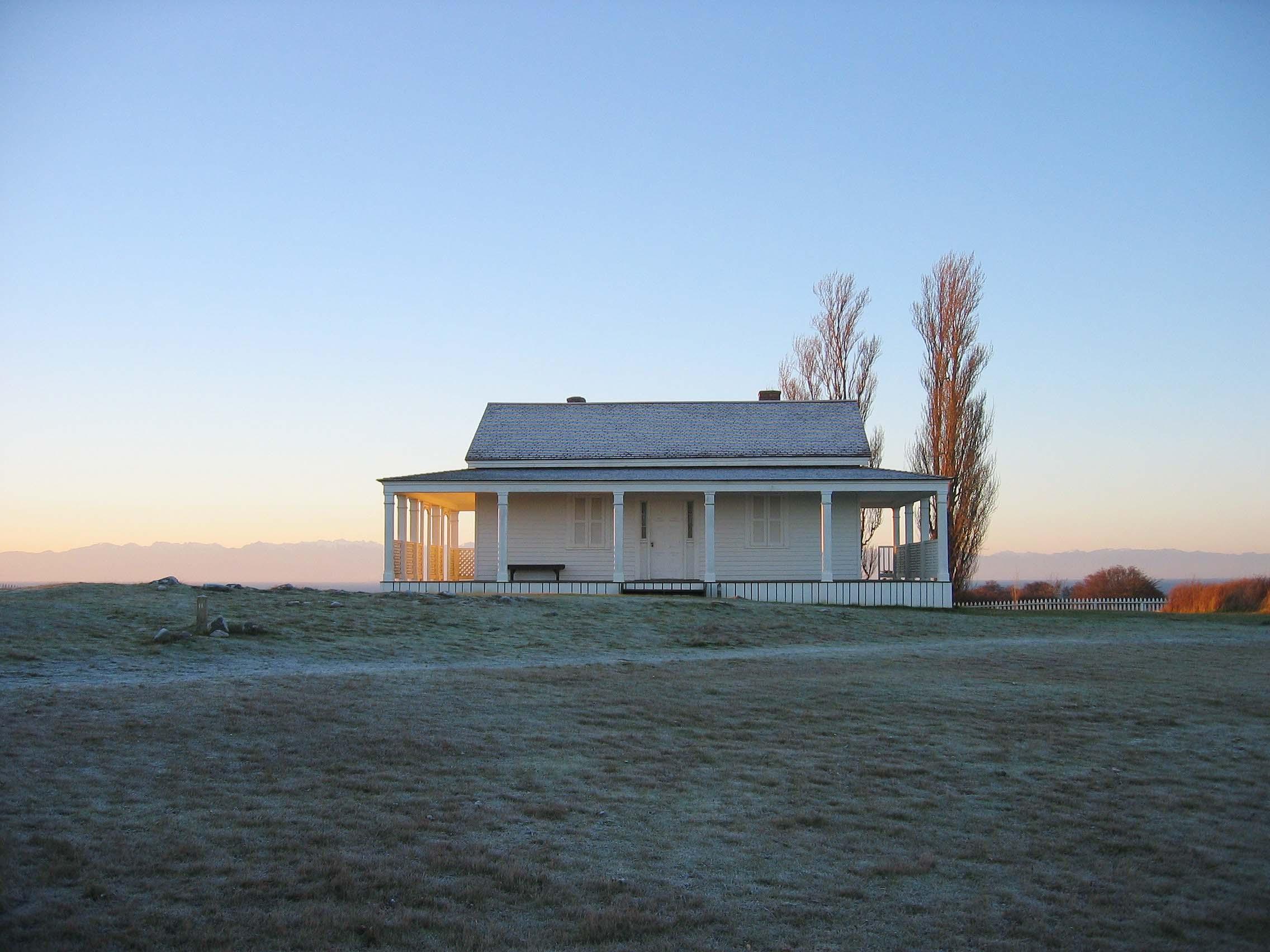 White building with rising sun in background