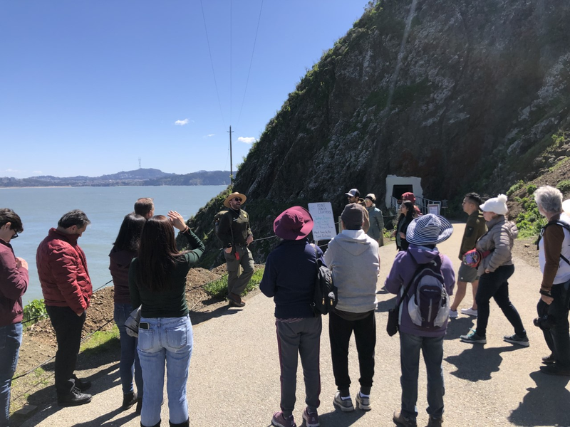 Image of a uniformed NPS Interpretive Park Ranger leading a "Light Chat" at Point Bonita