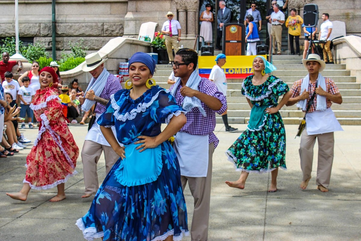 A group of Colombian dancers perform in an outdoor plaza