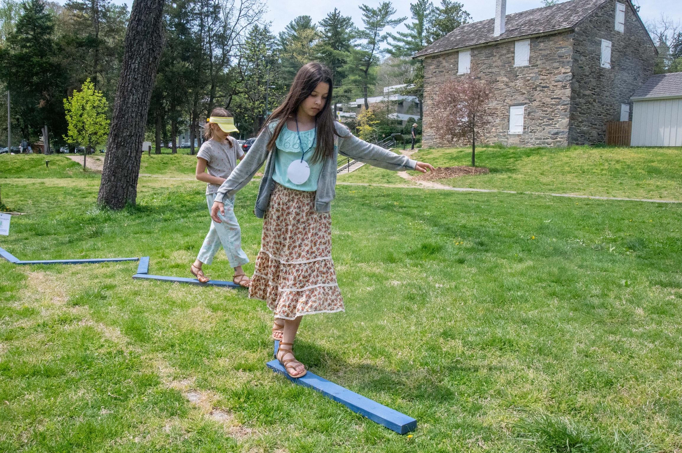 children walking on low balance beams